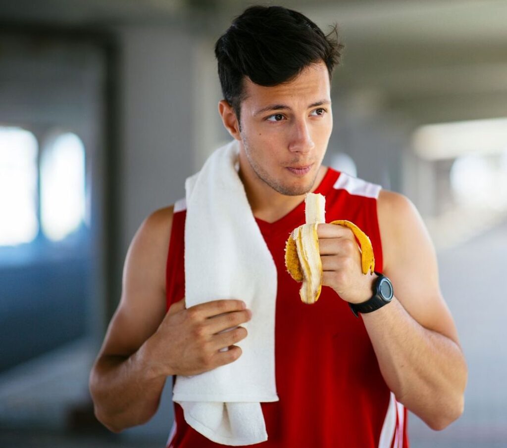 athlete eating a banana