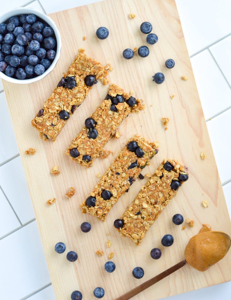 These No-Bake Blueberry Granola bars feature fresh blueberries and have very little added sugar. With just a few simple ingredients and no oven required, there are the perfect nutritious snack to whip up in the heat of the summer or anytime throughout the year! #nobake #granolabars #blueberrybars #healthysnack #healthygranolabar