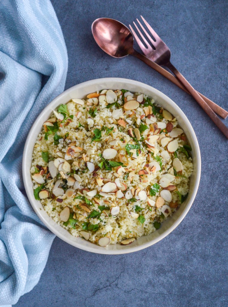 couscous with zaatar vinaigrette in white bowl with silverware