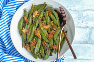 Recipe for Parmesan Roasted Snap Peas. Delicious spring side that comes together in minutes. #sidedish #protein #springrecipe #snappeas #cheesy #parmesan #healthy #lowcalorie
