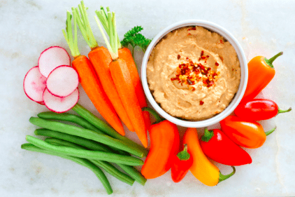 mixed veggies with hummus on marble background